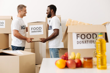Handsome productive men working in a warehouse for charity