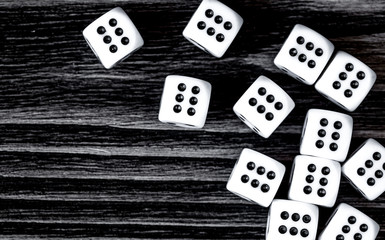 risk concept playing dice at dark wooden background top view