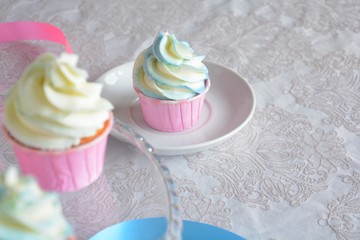 homemade cupcakes on the plate with the pink and blue tapes on the background