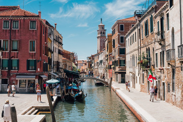 View on a venetian canal with ancient buildings and bridge in Venice