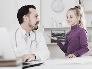 Male doctor and little girl