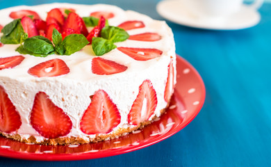 Strawberry cake with sour cream on a blue background