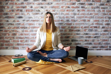 Young woman sits on the floor and meditates