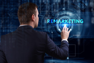 Business, Technology, Internet and network concept. Young businessman working on a virtual screen of the future and sees the inscription: Remarketing