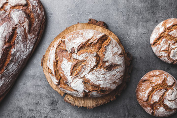 Delicious fresh bread on rustic background