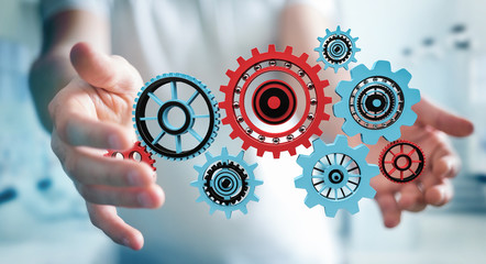 Businessman holding floating gear icons in his hand 3D rendering