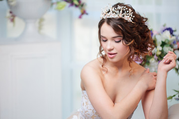 Portrait, wedding hair style, brunette with curly hair. Beautiful girl in a wedding dress. Close-up © Ulia Koltyrina