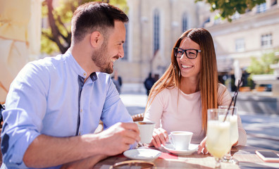 Romantic couple drinking coffee and lemonade, having a date in the cafe. Dating, love, relationships