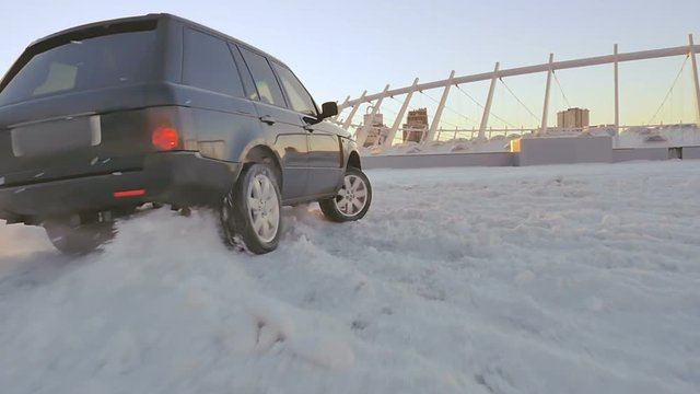 The car drifting on winter sunset background