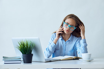 Young beautiful woman working at computer in office