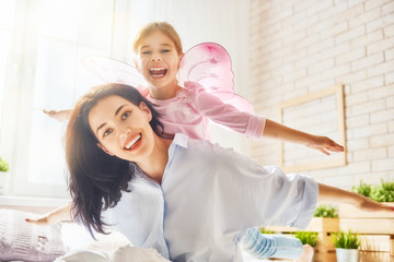 Mother and daughter playing and hugging