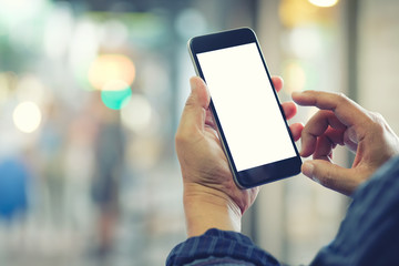 Man using smartphone at street night.