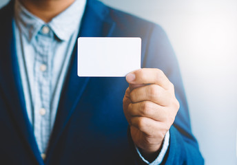 Man holding white business card,Man wearing blue shirt and showing blank white business card. Blurred background. Horizontal mockup, Smart asian business Person Professional Occupation cheerful