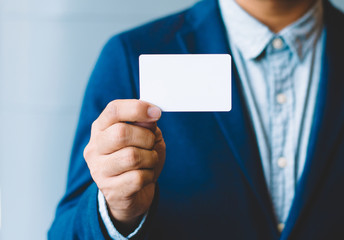 Man holding white business card,Man wearing blue shirt and showing blank white business card. Blurred background. Horizontal mockup, Smart asian business Person Professional Occupation cheerful