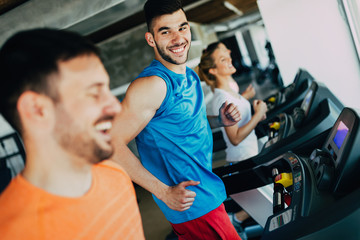Group of friends exercising on treadmill machine