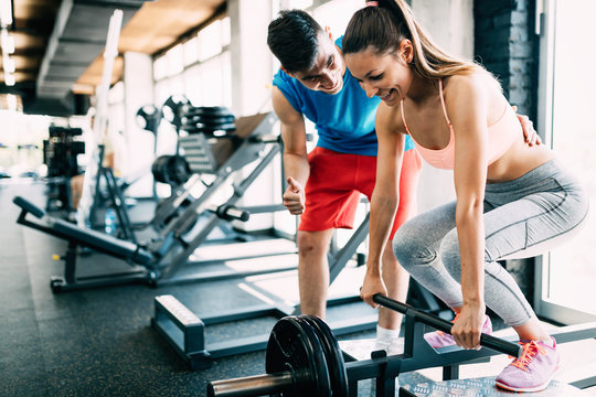 Atrractive woman doing exercises for back in gym