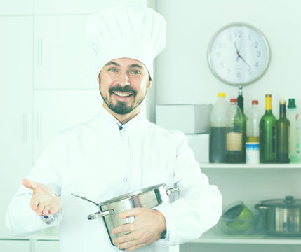 Male cook tasting food