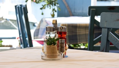 Salt, pepper and oil on a table in a restaurant