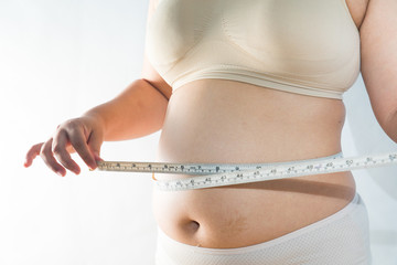 big belly of a fat man and measuring tape isolated on white