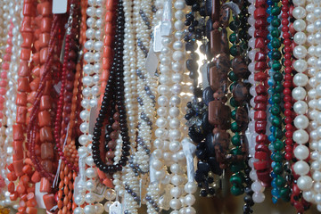 Colorful pearl, coral and stone beads, background, texture