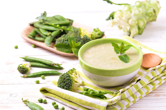 Broccoli And Green Peas Puree Soup Decorated With Mint