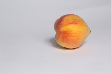 single ripe peach isolated on white background
