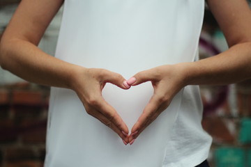 Young woman's hands shows heart. Gesture.