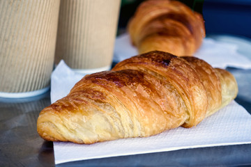 Breakfast with coffee and croissants on table