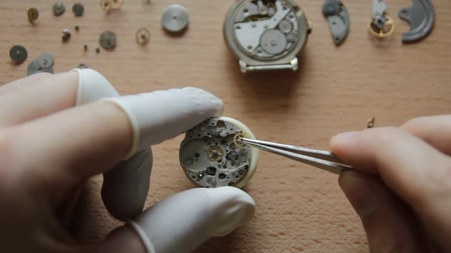 The watchmaker is repairing the mechanical watches