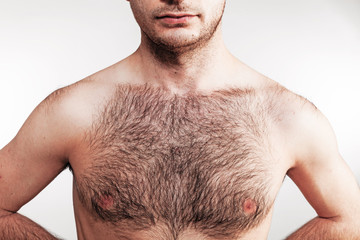 Boy with naked hairy chest on white background