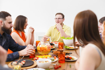 Obraz na płótnie Canvas Group of happy people at festive table dinner party