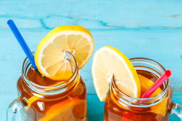 Iced tea in a glass jar with lemon.