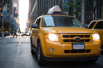 Yellow Cab in Manhattan - New York City. Taxi car in city at sunset. 