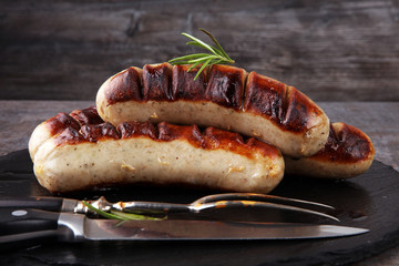 Grilled sausages with sauce ketchup on a wooden table - Home-made Pork Sausages