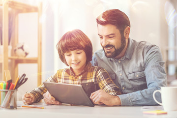 Joyful happy man spending time with his son