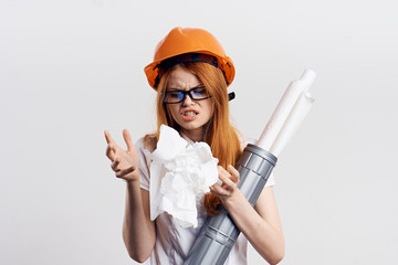 Young beautiful woman on white isolated background holds blueprints