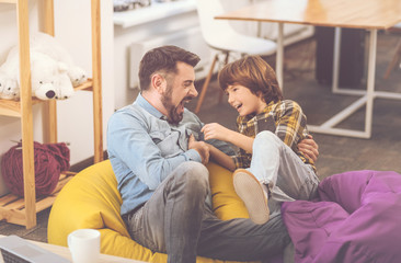 Cheerful happy father and son laughing