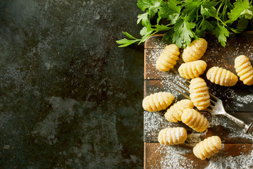 Freshly made gnocchi dumplings with parsley - obrazy, fototapety, plakaty