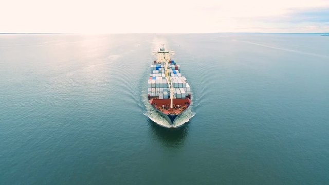 Aerial view of container vessel sailing in open sea