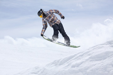 Fototapeta na wymiar Flying snowboarder on mountains
