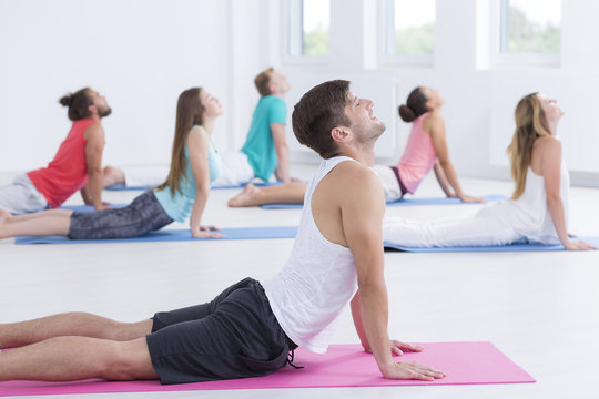 Male yoga instructor teaching class