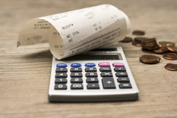 Close up shot of calculator and shopping receipt