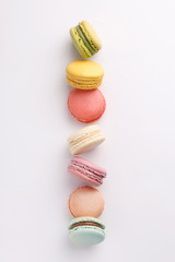 Macarons on white background. Colorful french desserts. Top view