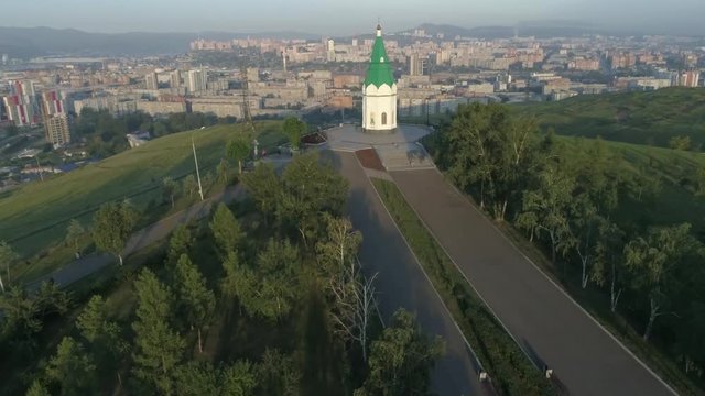 Church of Paraskeva Pyatnitsa is symbol of Krasnoyarsk. City in Siberia, Russia. Russian old architecture. Aerial drone flight around. 4K format