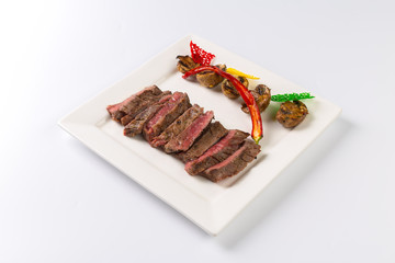 Juicy steak medium rare beef with spices and grilled vegetables