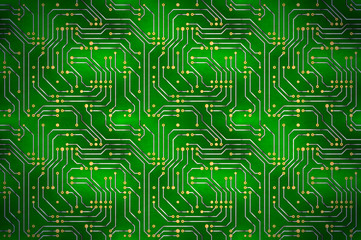 Complicated computer microchip with golden contacts on green motherboard