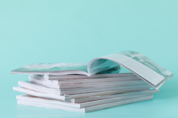 side view of a stack of magazines with glossy paper