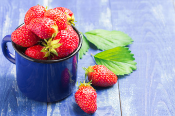 Delicious garden berries on wooden table.
