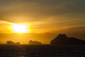 Naklejka na ściany i meble Icebergs in Antarctica at sunset