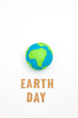 Globe ,earth made from clay and letter earth day on white background with copy space. Concept Save green planet. Earth day holiday concept